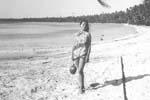 Gail Howard in Fakahina 1963. Gail Howard wearing a pareu, holding a coconut.